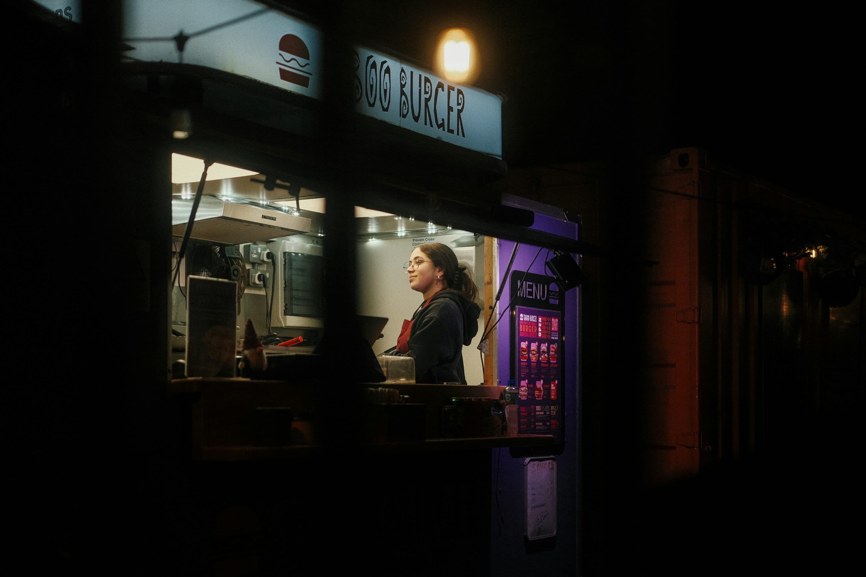 Small business owner serving a customer at the shop counter