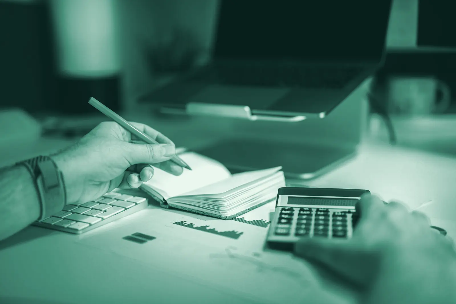Illustrative photo: paperwork and a laptop on a workshop office desk.
